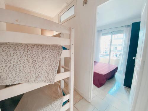 a small room with a bunk bed and a bedroom at Superbe Appartement Vue mer in Canet-en-Roussillon