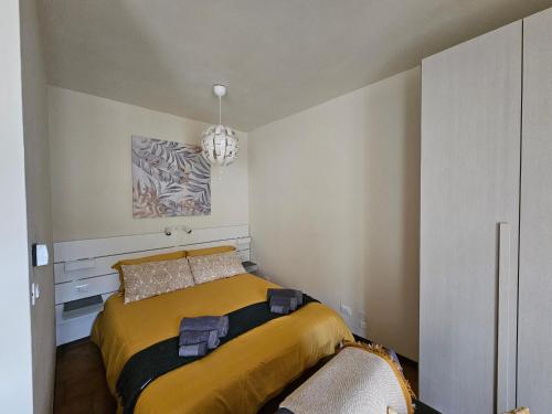 a bedroom with a bed and a chandelier at Ca' Tecla in Asti