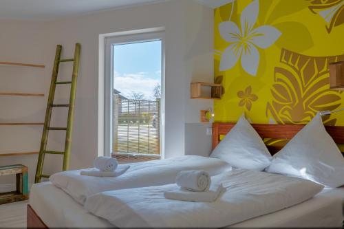 a bedroom with two beds with towels on them at Typ C1 Lodge - Napali Coast in Pelzerhaken