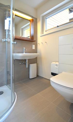 a bathroom with a toilet sink and a shower at Typ C2 Mini Lodge - Kalama Beach Park 2 in Pelzerhaken
