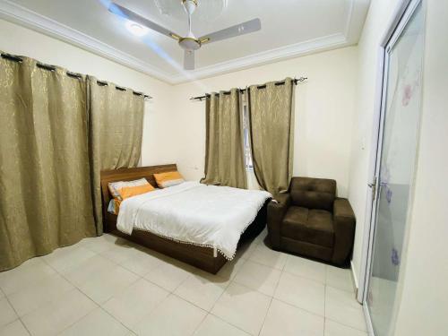 a small bedroom with a bed and a chair at Danso apartment in Tokuse