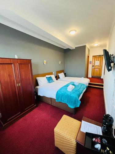 a hotel room with a large bed and a couch at George And Dragon Place in Chester