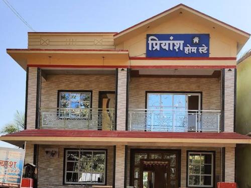 a building with a sign on top of it at Priyansh Home stay in Harihareshwar
