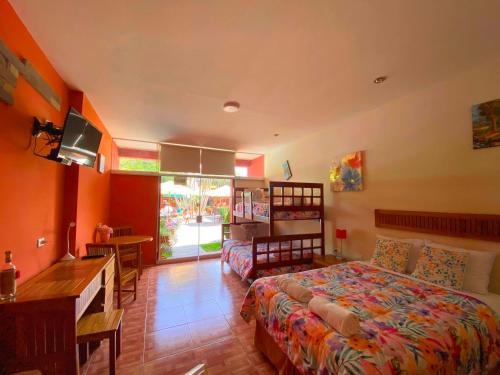 a bedroom with a bed and a desk and a desk at Huertalejandro Restaurante Campestre y Hospedaje in Cieneguilla