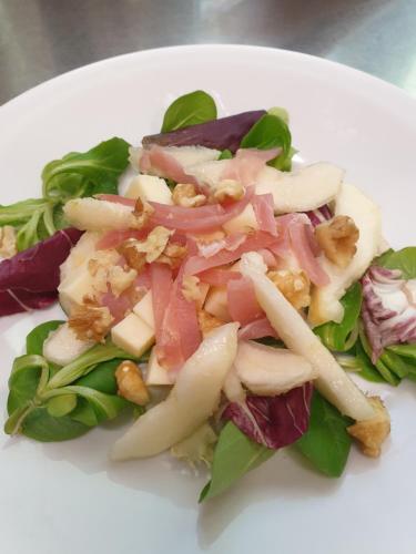 a white plate of food with a salad on it at Agriturismo La.Ti.Mi.Da. in Cassine