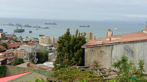 a view of a city with boats in the water at Hostal Florida Valpo in Valparaíso