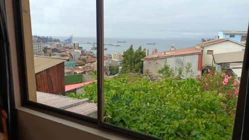 a window with a view of a city at Hostal Florida Valpo in Valparaíso
