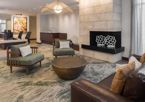 a lobby with chairs and a fireplace in a hotel at Fairfield Inn & Suites by Marriott Tampa Westshore/Airport in Tampa