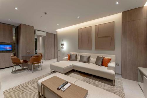a living room with a couch and a table at Residence Inn by Marriott Antalya in Antalya