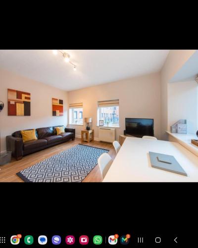a living room with a large bed and a couch at The Maltings in Edinburgh
