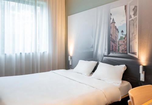 Ένα ή περισσότερα κρεβάτια σε δωμάτιο στο B&B HOTEL Toulouse Basso Cambo