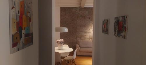 a living room with a table and a couch at Dimora Farini in Modena