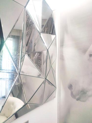 a glass wall with a mirror on a wall at Casa Louise - appartamento Don Bedetti in Bologna