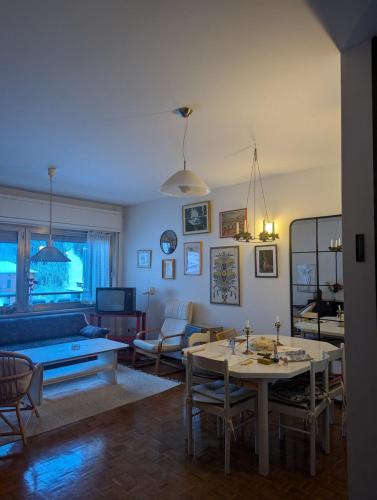 a living room with a table and a couch at Spacious family home in Ravascletto in Ravascletto