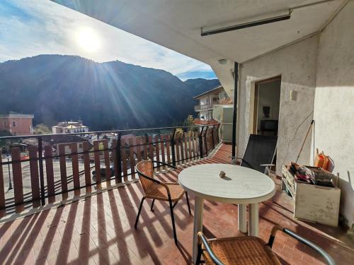 a balcony with a table and chairs and a view at Spacious family home in Ravascletto in Ravascletto