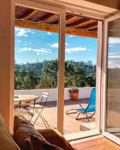 a living room with a view of a patio at Monte da Caniveta - Casa do Avô in São Luis