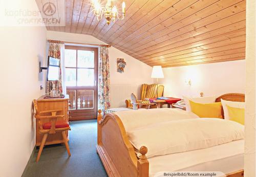a bedroom with a large bed and a window at Edelweißhof in Ischgl