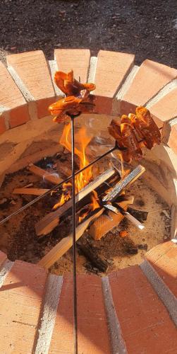 a fire in a brick fire pit on the street at AlVa- relax a oddych v Slovenskom raji in Dedinky