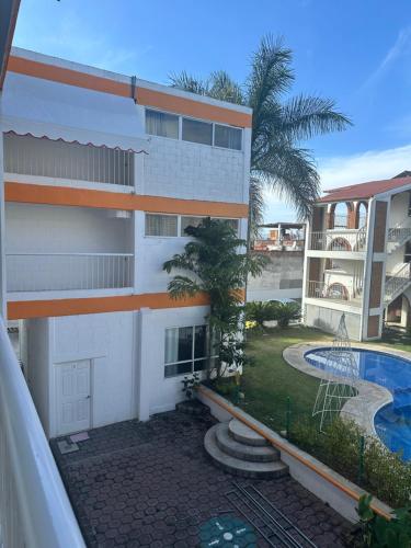 an external view of a building with a swimming pool at Hotel El Romano in Ixtapan de la Sal