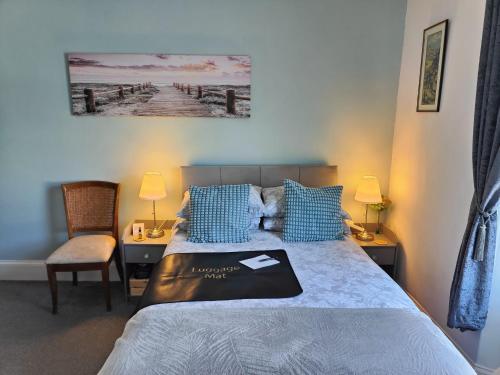 a bedroom with a bed and a desk with two lamps at The Garway in Torquay