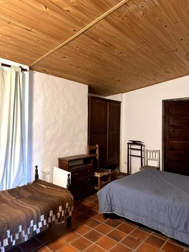 En eller flere senge i et værelse på Casa Los Membrillos