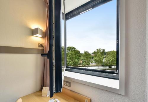 a window in a room with a view at B&B HOTEL Toulouse Centre Canal du Midi in Toulouse