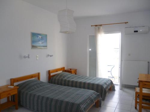 Ένα ή περισσότερα κρεβάτια σε δωμάτιο στο Marathi Apartments 