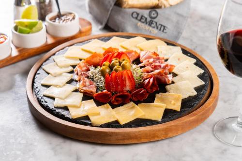 a plate of cheese and meats on a table at Hotel GRALTA in Jalostotitlán