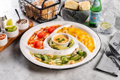a plate of food with vegetables and fruit on a table at Hotel GRALTA in Jalostotitlán