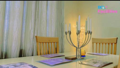 a table with two chairs and a vase with candles on it at Agnes Court in Nopendaw