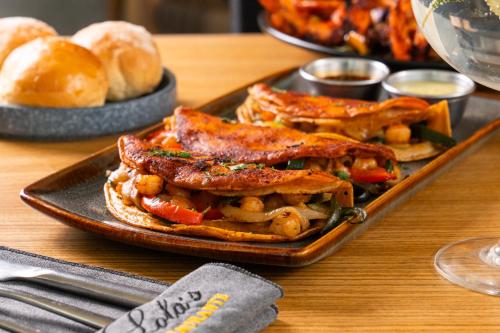 a plate of food on a table with bread at Hotel GRALTA in Jalostotitlán
