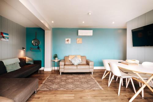 a living room with a couch and a table at Cliff Cottage - Luxurious Seaview Retreat in Gorleston-on-Sea