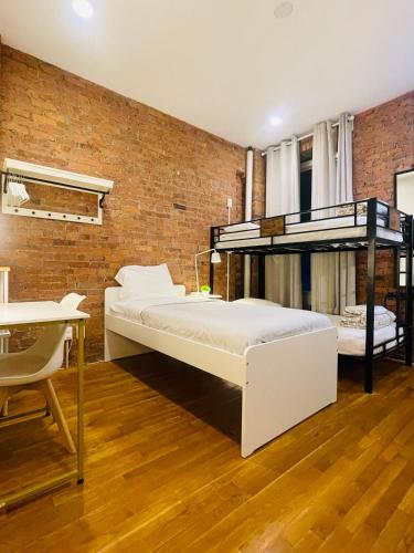 two bunk beds in a room with a brick wall at Hotel and the City, Empire State Building in New York