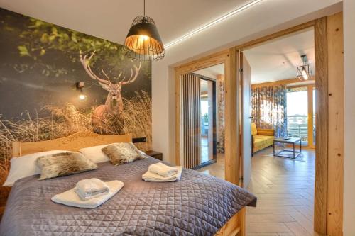 a bedroom with a bed with towels on it at Santa Angela Solina Centrum - Apartamenty in Solina