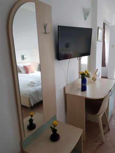 a room with a mirror and a desk and a bed at Family Hotel Magnolia, Sunny Beach in Sunny Beach