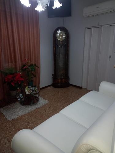 a room with a bed and a grandfather clock at Dimora ANETT B&B HOUSE in Codevigo
