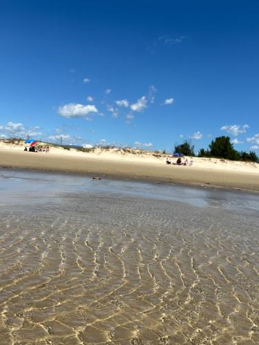 a beach with ripples in the sand at Casa de praia com suíte master in Arroio do Sal