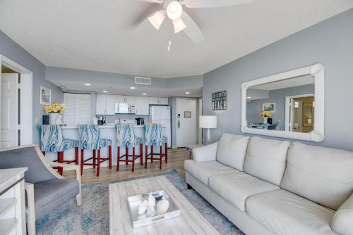 a living room with a white couch and a kitchen at The Salt Cay - Sunrise Suites in Key West