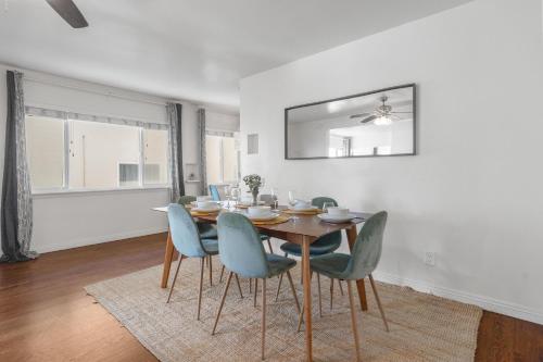 a dining room with a table and blue chairs at Coastal Hideaway in San Diego