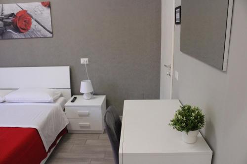 a bedroom with a bed and a table with a plant at B&B Il terrazzo da Gregorio in Rome