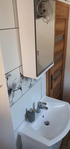 a bathroom with a white sink and a mirror at AlVa- relax a oddych v Slovenskom raji in Dedinky