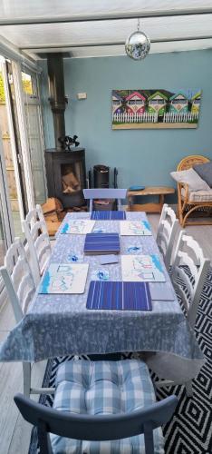 a dining room with two tables and chairs and a fireplace at Beach house Mablethorpe Stylish Spacious, 2 bedrooms sleeps 6 200m to beach in Mablethorpe