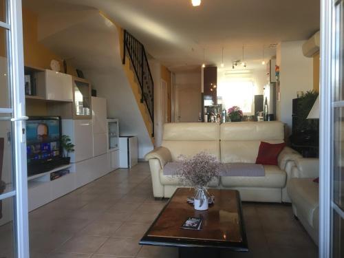 un salon avec un canapé et une table dans l'établissement maison au bord de l'eau, à Aigues-Mortes