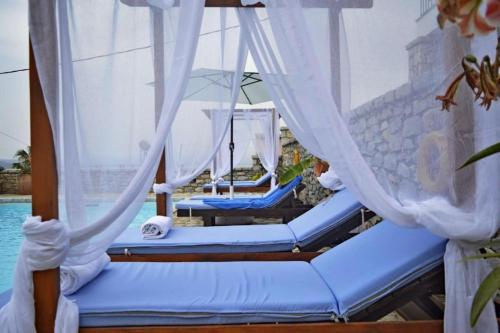 a couple of beds on a boat in the water at Malvazios Villas #3 in Gythio