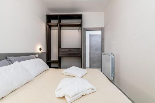 two white towels on a bed in a room at Villa Apeliote in Carovigno