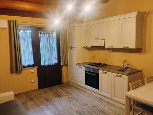 a kitchen with white cabinets and a stove top oven at Casa LEPRICE in SantʼElpidio a Mare
