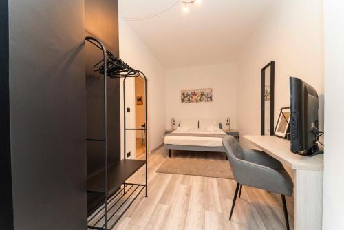 a bedroom with a bed and a desk with a television at Homely Business 2 in Turin