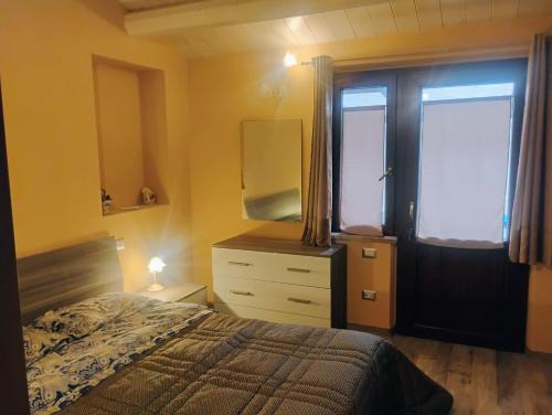 a bedroom with a bed and a dresser and a window at Casa LEPRICE in SantʼElpidio a Mare