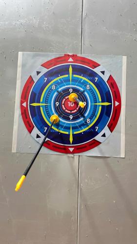 a dart board on a wall with a bat at HOMESTAY Hoàng GIa in Ấp Ông Tú