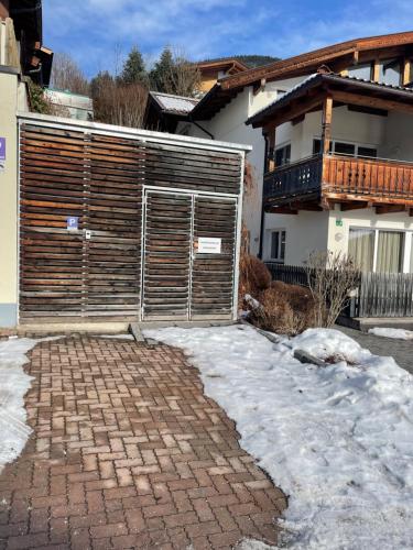 a brick driveway with a gate in front of a house at Select Apartment Top 13by Alpina in Piesendorf